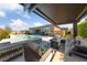 Relaxing backyard oasis with a covered patio and a sparkling swimming pool and spa for outdoor enjoyment at 6192 Lautman Ridge Ct, Las Vegas, NV 89141