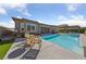 Enjoy the backyard pool and patio area with comfortable seating, perfect for outdoor entertaining and relaxation at 6192 Lautman Ridge Ct, Las Vegas, NV 89141