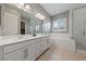 Elegant bathroom features a double vanity, soaking tub, and glass-enclosed shower at 6192 Lautman Ridge Ct, Las Vegas, NV 89141
