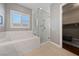 Bright bathroom featuring a modern glass-enclosed shower and soaking tub at 6192 Lautman Ridge Ct, Las Vegas, NV 89141