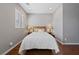 Cozy bedroom with hardwood floors, ambient lighting, and a comfortable bed at 6192 Lautman Ridge Ct, Las Vegas, NV 89141