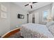 Serene bedroom showcasing a patterned queen bed, closet, and a wall-mounted TV for ultimate relaxation at 6192 Lautman Ridge Ct, Las Vegas, NV 89141
