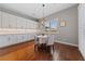 Bright dining area features hardwood floors, decorative light fixture, and white cabinets at 6192 Lautman Ridge Ct, Las Vegas, NV 89141