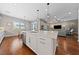 Open concept kitchen with a large island, modern appliances, and a seamless flow into the living area at 6192 Lautman Ridge Ct, Las Vegas, NV 89141