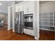 Stainless steel refrigerator and built-in microwave in a modern kitchen, with an adjacent walk-in pantry at 6192 Lautman Ridge Ct, Las Vegas, NV 89141