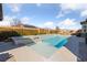 Stunning backyard pool and spa, bordered by manicured hedges and a spacious patio area for outdoor enjoyment at 6192 Lautman Ridge Ct, Las Vegas, NV 89141