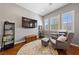 Relaxing sitting room with hardwood floors, comfortable seating, and natural light at 6192 Lautman Ridge Ct, Las Vegas, NV 89141