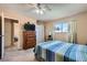 This bedroom features neutral walls, carpet, ceiling fan, and natural lighting at 6312 Portola Rd, Las Vegas, NV 89108