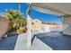 Covered patio area with brick pavers, lush plants, and a storage shed near the sparkling pool at 6312 Portola Rd, Las Vegas, NV 89108