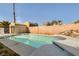 Sparkling pool with rock waterfall feature, a tanning ledge, and privacy wall, perfect for outdoor enjoyment at 6312 Portola Rd, Las Vegas, NV 89108