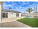 Backyard with artificial grass, swimming pool, and patio at 6597 Mountainwood Ln, Las Vegas, NV 89103