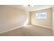 Comfortable bedroom with neutral carpet, modern light fixture, and window at 6597 Mountainwood Ln, Las Vegas, NV 89103