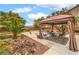 Relaxing backyard with gazebo, rock garden and palm tree, perfect for outdoor entertaining and enjoying the serene environment at 6736 Sugarbird Ct, North Las Vegas, NV 89084