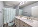 Bathroom with double vanity, shower with curtain and tile flooring at 6736 Sugarbird Ct, North Las Vegas, NV 89084