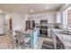 Beautiful kitchen boasts stainless steel appliances, granite countertops, and a stylish center island with barstool seating at 6736 Sugarbird Ct, North Las Vegas, NV 89084