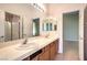 Bright bathroom featuring double sinks, large mirrors, and neutral tones at 6741 Philippe Allen Ave, Las Vegas, NV 89110