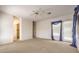 Spacious bedroom featuring neutral paint, carpet floors, and natural light from the windows at 6741 Philippe Allen Ave, Las Vegas, NV 89110