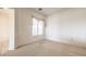 A bright bedroom with a large window and neutral-toned walls at 6741 Philippe Allen Ave, Las Vegas, NV 89110