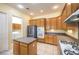 Updated kitchen featuring stainless steel appliances, wood cabinets and center island at 6741 Philippe Allen Ave, Las Vegas, NV 89110