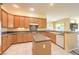 Bright kitchen with stainless steel appliances, tile floors and central island at 6741 Philippe Allen Ave, Las Vegas, NV 89110