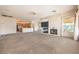 Open-concept living room featuring a fireplace, large windows, and connection to the kitchen at 6741 Philippe Allen Ave, Las Vegas, NV 89110