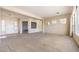 Open-concept living area with a large window, and entryway, showcasing the spacious floor plan at 6741 Philippe Allen Ave, Las Vegas, NV 89110