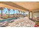 Beautiful outdoor patio with a pool, palm trees, and ample seating areas at 6741 Philippe Allen Ave, Las Vegas, NV 89110