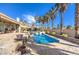 Beautiful backyard featuring a sparkling pool, stone patio, and privacy landscaping, ideal for entertaining at 6741 Philippe Allen Ave, Las Vegas, NV 89110