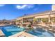 Lush backyard with a refreshing pool and spa, framed by manicured landscaping and a cozy patio area at 6741 Philippe Allen Ave, Las Vegas, NV 89110