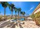 Inviting backyard pool and spa, accented by lush palm trees and a stone patio for outdoor relaxation at 6741 Philippe Allen Ave, Las Vegas, NV 89110