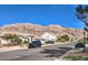 Picturesque street view showcasing well-manicured homes and mountain views, capturing the neighborhood's charm at 6741 Philippe Allen Ave, Las Vegas, NV 89110