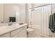 Bright bathroom showcasing a shower-tub combination with white tiling and modern fixtures at 758 Marigold Sunrise St, Henderson, NV 89011