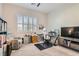 Bright bedroom featuring a comfortable chair, desk, and shelving for a functional workspace at 758 Marigold Sunrise St, Henderson, NV 89011