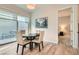 Cozy dining area with wood floors and easy access to the backyard and adjacent bedroom at 758 Marigold Sunrise St, Henderson, NV 89011