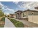 Well-maintained exterior showcasing the home's design, complemented by manicured landscaping and a paved pathway at 758 Marigold Sunrise St, Henderson, NV 89011