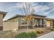 Charming single story home featuring a covered porch and desert landscaping at 758 Marigold Sunrise St, Henderson, NV 89011