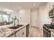 Modern kitchen featuring granite countertops, stainless steel appliances, and wooden floors at 758 Marigold Sunrise St, Henderson, NV 89011