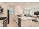 Open concept kitchen with stainless steel appliances, a center island with granite countertop, and wood look flooring at 758 Marigold Sunrise St, Henderson, NV 89011