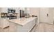 Modern kitchen features stainless steel appliances, gray backsplash, white cabinets and granite countertops at 758 Marigold Sunrise St, Henderson, NV 89011