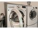 Well-equipped laundry room featuring a front-load washer and dryer for efficient cleaning at 758 Marigold Sunrise St, Henderson, NV 89011