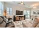 Comfortable living room with large windows, ceiling fan and modern decor and plenty of seating at 758 Marigold Sunrise St, Henderson, NV 89011