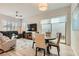 Open-concept living room with stylish furnishings and access to an outdoor patio space at 758 Marigold Sunrise St, Henderson, NV 89011