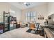 Bright office with a ceiling fan, a large desk, and a comfortable reading chair at 758 Marigold Sunrise St, Henderson, NV 89011