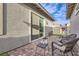 Charming outdoor patio with stone pavers, seating, and sliding glass doors leading inside at 758 Marigold Sunrise St, Henderson, NV 89011