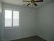 Cozy bedroom with white walls, wood flooring, ceiling fan and window with plantation shutters at 7929 Palace Monaco Ave, Las Vegas, NV 89117