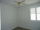 This is a basic bedroom shot with white walls, ceiling fan and window with plantation shutters at 7929 Palace Monaco Ave, Las Vegas, NV 89117