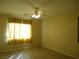 Bedroom featuring tile floors, natural lighting, and a ceiling fan at 7929 Palace Monaco Ave, Las Vegas, NV 89117