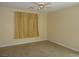 This bedroom is simple with neutral colored walls, tile flooring, and a ceiling fan at 7929 Palace Monaco Ave, Las Vegas, NV 89117