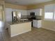 Bright kitchen features white cabinets, stainless steel appliances, and granite countertops at 7929 Palace Monaco Ave, Las Vegas, NV 89117