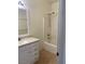 Bright bathroom with white cabinets, countertop, tile floor, and a shower/tub combo at 8212 Calico Wind St, Las Vegas, NV 89131
